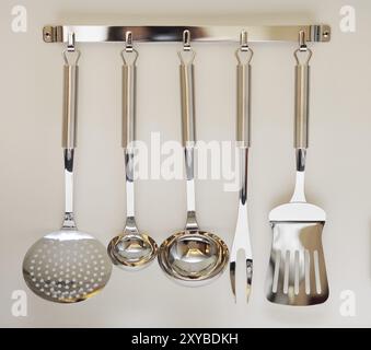 Set di moderno nero arnese da cucina appeso su sfondo beige Foto Stock