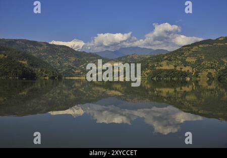 Picco innevato della catena dell'Annapurna che si specchia nel lago Begnas tal. Scena autunnale vicino a Pokhara, Nepal, Asia Foto Stock