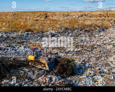 Spazzatura e bulldozer di lavoro, vista aerea. Foto Stock