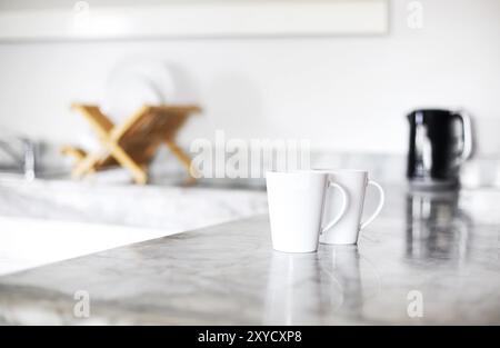 Vista ravvicinata di due tazze di caffè per colazione sul tavolo bianco in cucina Foto Stock