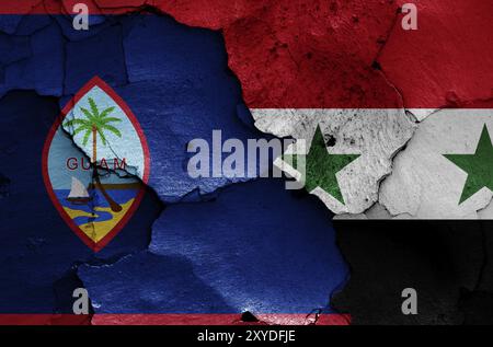 Bandiere di Guam e Siria dipinte su pareti incrinate Foto Stock