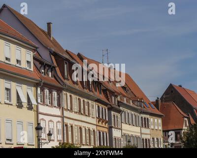 Fila di case in legno con persiane colorate e tetti di tegole rosse in una strada storica, Weissenburg, Alsazia, Francia, Europa Foto Stock