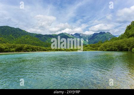 Paesaggio di acque turchesi del litorale dello stagno di Taisho con vista della natura del Monte Hotaka Dake sullo sfondo in una giornata estiva nel villaggio delle Alpi giapponesi Foto Stock