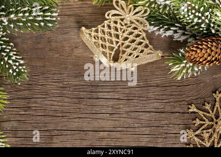 Bordo natalizio dal ramo e campane su sfondo in legno Foto Stock