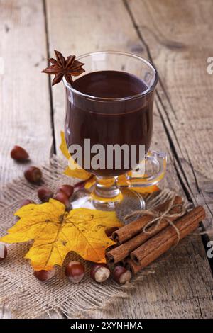 In casa la cioccolata calda con nocciole e cannella su sfondo di legno Foto Stock