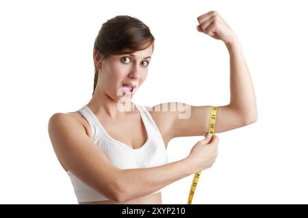 Scioccato donna misurando il suo bicipite, isolato in uno sfondo bianco Foto Stock