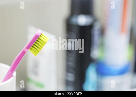 Spazzolino da denti colorati in bagno, routine mattutina Foto Stock