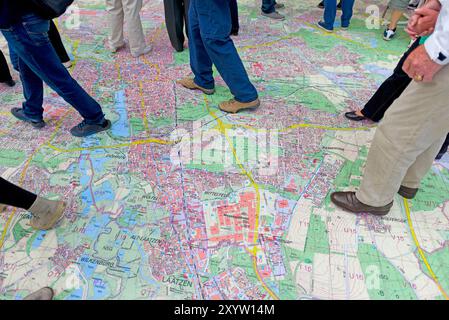 Pedoni che camminano su una mappa della città di Hannover, motto domenica senza auto, Hannover, bassa Sassonia, Germania, Europa Foto Stock