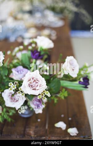 Bouquet di fiori di colore rosa su un tavolo per la cena, close up Foto Stock