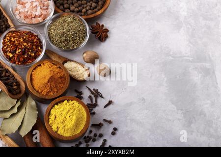 Le spezie e le erbe oltre la pietra grigia sfondo vista superiore con spazio libero per menu o ricette Foto Stock