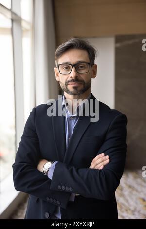 Un serio uomo d'affari latino di mezza età che guarda la macchina fotografica Foto Stock