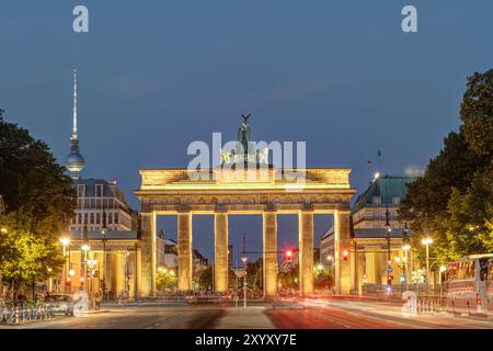 La porta di Brandeburgo e la torre della televisione di Berlino al tramonto Foto Stock