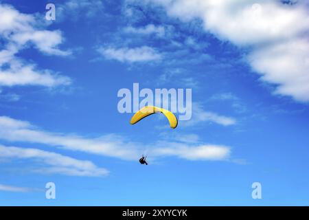 Parapendio volare da soli con il blu del cielo in background Foto Stock