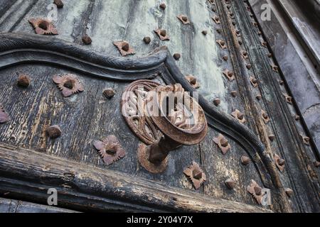 Antico battente di metallo su ferro battuto ha rinforzato vecchie porte in legno alla Cattedrale di Girona, Spagna, Europa Foto Stock