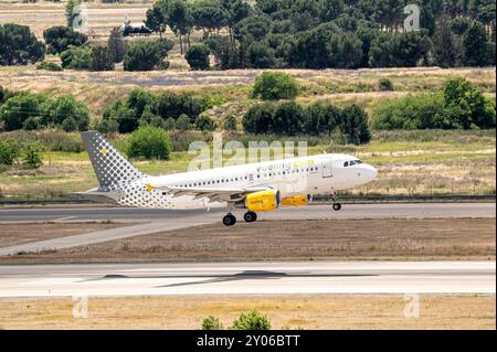 Madrid, Spagna; 05-18-2024: Aereo modello Airbus A319 della compagnia aerea low-cost spagnola Vueling che atterra sulla pista dell'aeroporto Foto Stock