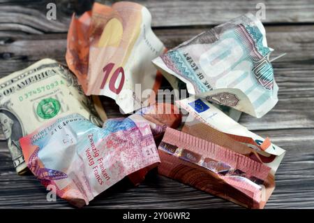 Sfondo di banconote piegate e stropicciate da 100 sterline egiziane EGP, 1 dollaro americano, 10 euro, 20 franchi svizzeri CHF, b Foto Stock