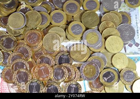 Monete di riyal saudita, 2, 1, mezza e un quarto di moneta su banconote in denaro saudita di riyal banconote, di diversi valori, moneta ed economia Foto Stock