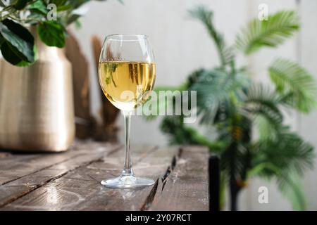 Il vino bianco viene versato in bolle in un primo piano in un bicchiere Foto Stock