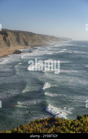 Spiaggia di Magoito con surfisti che navigano sulle onde del mare a Sintra, Portogallo, Europa Foto Stock