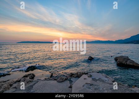 Tramonto colorato sulla Riviera di Makarska, famosa costa turistica del Mare Adriatico nella contea di Spalato-Dalmazia della Repubblica di Croazia Foto Stock