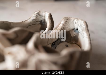 Primo piano di sneakers ben usate, che mettono in risalto l'usura, rappresentando la tendenza principale del sottoconsumo incentrata sulla sostenibilità e sulla consapevolezza Foto Stock