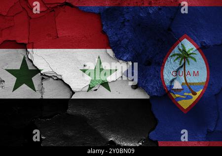 Bandiere di Siria e Guam dipinte su pareti incrinate Foto Stock
