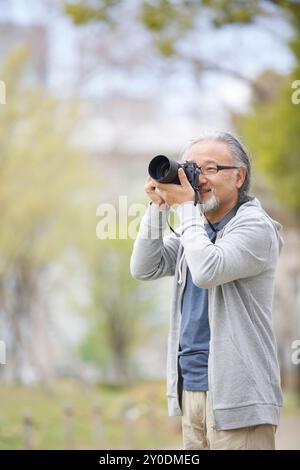 Un uomo anziano che fa una foto Foto Stock