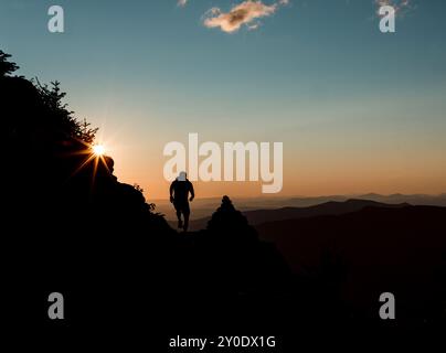 Runner ha sagomato contro il tramonto del sole nel New Hampshire Foto Stock