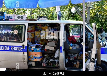 Tbilisi, Georgia - 8 ottobre 2023: Un furgone ingombrante con vari componenti elettronici e accessori in un mercato delle pulci in una giornata di sole Foto Stock