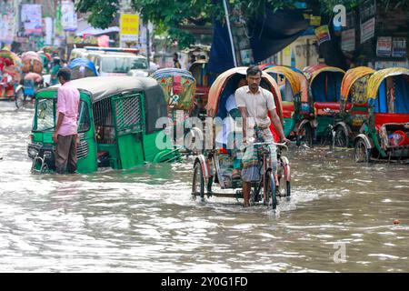 Dacca, Bangladesh. 2 settembre 2024. I pendolari attraversano una strada bagnata dopo forti piogge a Dacca, Bangladesh, il 2 settembre 2024. (Credit Image: © Suvra Kanti Das/ZUMA Press Wire) SOLO PER USO EDITORIALE! Non per USO commerciale! Crediti: ZUMA Press, Inc./Alamy Live News Foto Stock