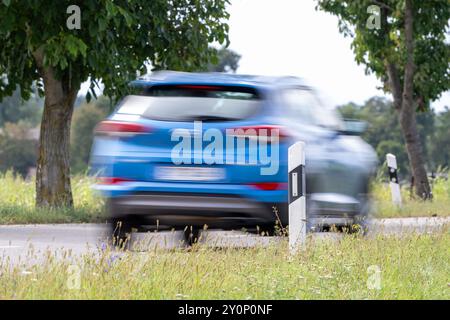 , Deutschland, 03.09.2024, Auf einer Landstraße fahren Autos an einem Leitpfosten vorbei. DAS Bild zeigt die Dynamik des Straßenverkehrs in einer län Foto Stock