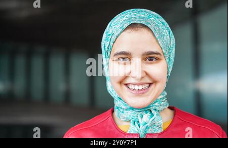 Giovane ragazza araba che indossa hijab mentre sorride all'aperto durante la stagione autunnale - concetto di cultura musulmana - Focus on Face Foto Stock