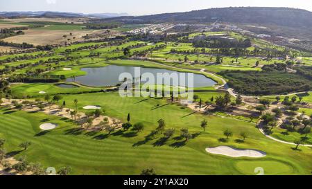 Ampia vista aerea di un lussuoso campo da golf con erba verde e lago Foto Stock