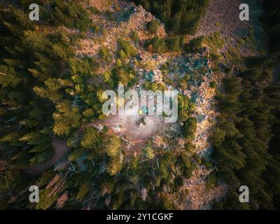 Campeggi giallo su una scogliera circondata da alberi Foto Stock
