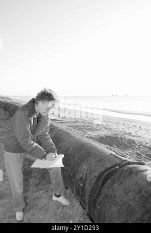 Donna caucasica, da 55 a 60 anni, che ispeziona un filone di condutture in un progetto di dragaggio a Myrtle Beach, South Carolina, USA. Foto Stock