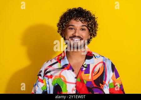 Foto di un bel giovane che sorride indossa una camicia isolata su sfondo giallo Foto Stock