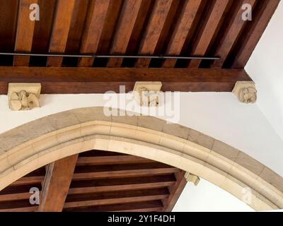 Bruges, Fiandre, Belgio - 25 giugno 2024: Storico municipio. Bottoni del soffitto scolpiti in pietra Foto Stock