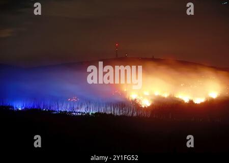 Wernigerode, Germania. 6 settembre 2024. Vista di fiamme e braci sul Königsberg nelle montagne Harz sotto il Brocken. Secondo un portavoce del distretto di Harz, molte aree di fuoco si erano fuse e si era sviluppato un fronte antincendio più grande. Circa 150 vigili del fuoco stanno ora lavorando a terra. Tre aerei e un elicottero sono stati anche coinvolti nel lavoro antincendio. Crediti: Matthias Bein/dpa/Alamy Live News Foto Stock