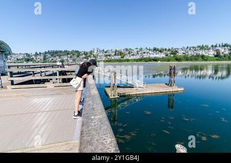 White Rock Pier e la baia semiahmoo acque interne nel Surrey, British Columbia, Canada. La città di White Rock ospita sul pendio della collina visto sullo sfondo Foto Stock