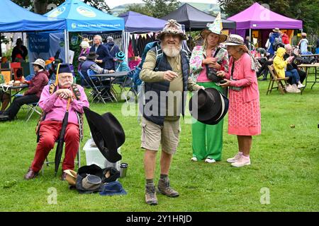 Bridport, Dorset, Regno Unito. 7 settembre 2024. Centinaia di persone che indossano cappelli decorati in modo creativo partecipano all'annuale Bridport Hat Festival a Bridport nel Dorset. Un frequentatore del festival che si reca alla gara di lancio dei cappelli. Crediti fotografici: Graham Hunt/Alamy Live News Foto Stock