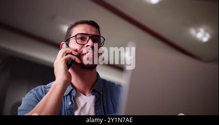 Portrait Of Young Happy Man Talking On Mobile Phone Foto Stock