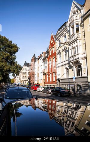 Le case della Spichernstreet si riflettono nel tetto di un'auto, Colonia, Germania. Gruenderzeitbauten in der Spichernstrasse spiegeln sich in einem Autodach, Foto Stock