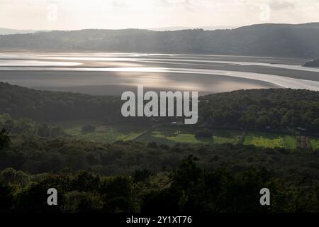 La luce del sole sull'estuario, vista da Arnside Knott con Grange-over-Sands in lontananza, Cumbria, Inghilterra. Foto Stock