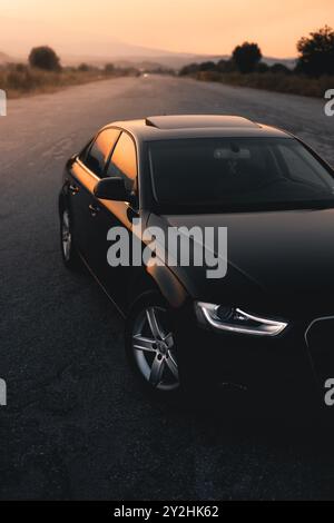 Bulgaria - 10 02 2024: Vista laterale di un'audi nera parcheggiata nel mezzo di un aeroporto abbandonato. Foto Stock