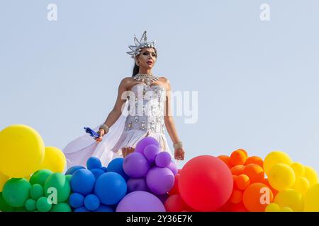 Goiânia GOIAS BRASILE - 08 SETTEMBRE 2024: Una persona LGBT, vestita di bianco con un galleggiante decorato con palloncini, ballando, alla LGBT Pride Parad del 2024 Foto Stock