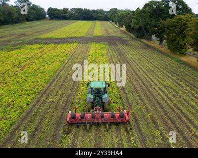 Vista aerea dell'agricoltore che lavora sul campo con trattore presso Drem nell'East Lothian, Scozia, Regno Unito Foto Stock