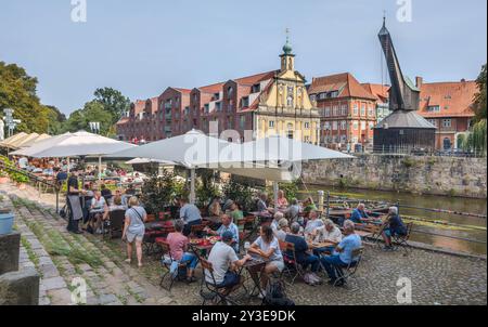 11 agosto 2024, bassa Sassonia, Lüneburg: Vista dallo Stintmarkt attraverso l'Ilmenau fino alla vecchia gru nel porto di Lüneburg. Foto: Markus Scholz/dpa Foto Stock