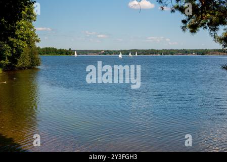 Barche a vela sull'acqua in Svezia. Bambini che navigano su un lago con piccole barche a vela (catamarani). Foto Stock