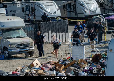 Sacramento, CA. 26 agosto 2024. Chastity May, 50, cammina con uno dei suoi tre cani Pico con la polizia cittadina di Sacramento mentre arrivano per smantellare Camp Resolution lunedì 26 agosto 2024. "La polizia è arrivata e ha detto che hanno superato l'applicazione del codice e che stanno per distruggere il mio veicolo in questo momento", ha affermato May. (Credit Image: © Renée C. Byer/ZUMA Press Wire) SOLO PER USO EDITORIALE! Non per USO commerciale! Foto Stock