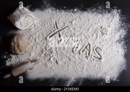 Vista ad angolo alto con un tavolo da cucina ricoperto di farina bianca e le parole Foto Stock